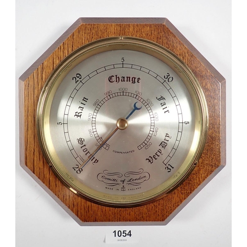 1054 - A Comitti octagonal oak barometer, 21cm