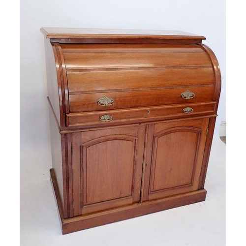 1057 - A Victorian walnut cylinder front desk with satinwood fitted interior all over cupboard on plinth ba... 