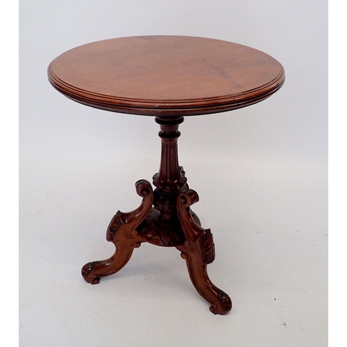 1058 - A Victorian mahogany tripod table with ornate scroll base, 56cm