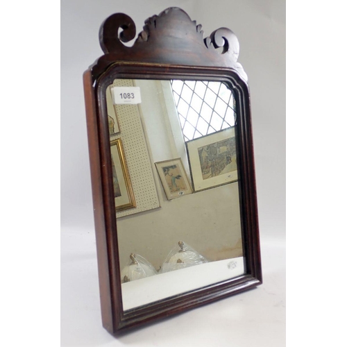 1083 - A 19th century mahogany easel mirror with scroll pediment, 43cm tall