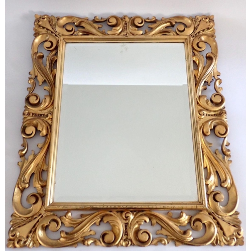 1084 - An Italian carved gilt scrollwork framed mirror, 55 x 65cm