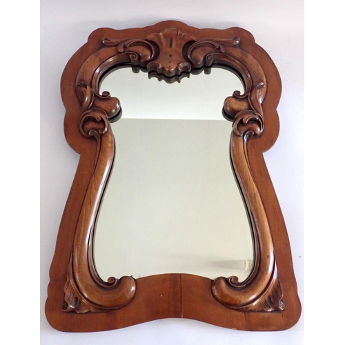 1085 - A mahogany wall mirror with carved scroll inner border, 68 x 48cm