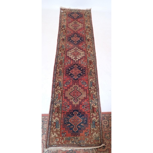 1087 - A Turkoman style runner with hooked  medallion design 293 x 76cm