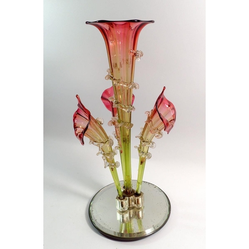 112 - A Victorian cranberry and green glass epergne with central trumpet and three outer trumpets, on a la... 