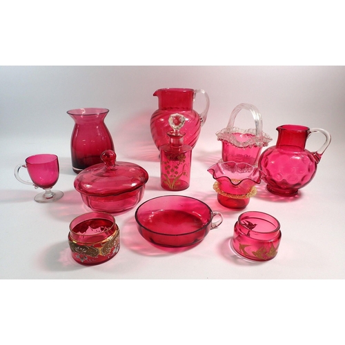 124 - A collection of cranberry glass including two jugs, powder bowl, basket vase etc.