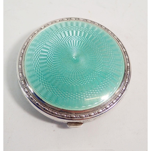 259 - A silver and green enamel compact, 5.5cm diameter Birmingham 1929 with patent insert by Crisford & N... 