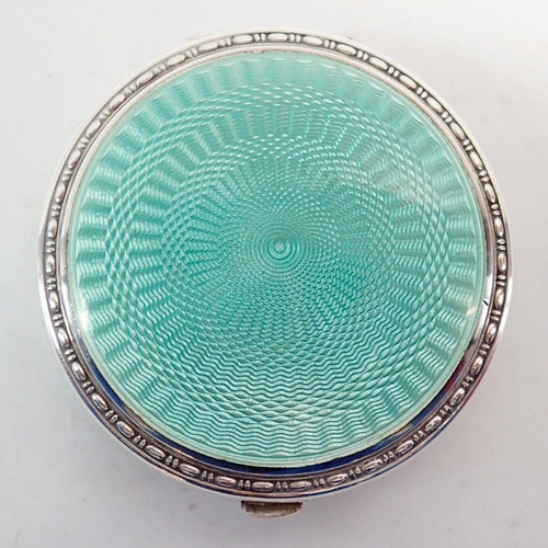 259 - A silver and green enamel compact, 5.5cm diameter Birmingham 1929 with patent insert by Crisford & N... 