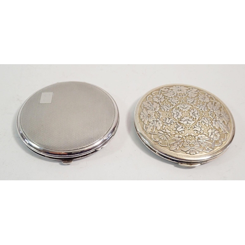 261 - Two silver circular compacts one with floral design, London 1959 by Kigu and an engine turned one wi... 