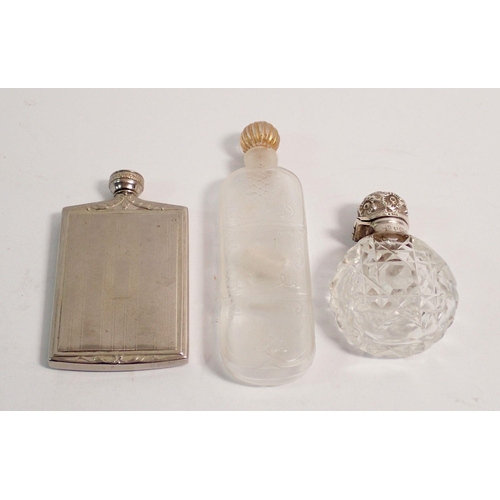 282 - A cut glass and silver mounted scent bottle, a glass scent bottle 9cm tall and a white metal one