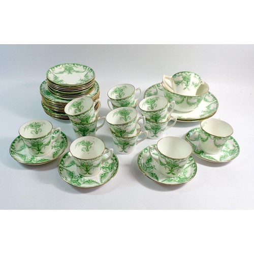 30 - An Edwardian green printed tea service comprising twelve cups and saucers, twelve tea plates, milk a... 