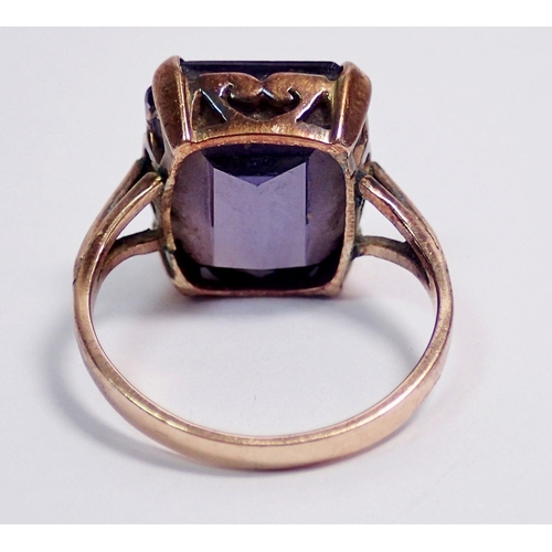 303 - A yellow metal ring set amethyst (tested as gold)  - size L