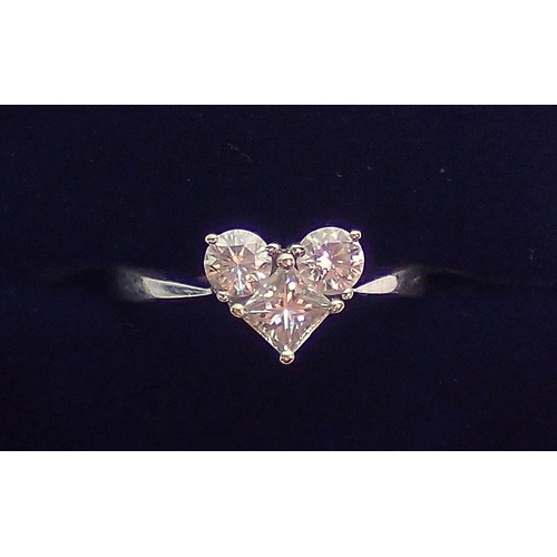 315 - An 18 carat white gold ring set two brilliant cut and one princess cut diamonds, forming a heart sha... 