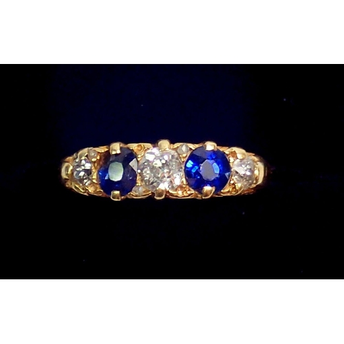 317 - An 18 carat gold ring set two sapphires and three diamonds, size N, 4.3g