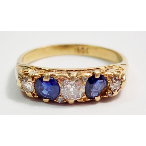 317 - An 18 carat gold ring set two sapphires and three diamonds, size N, 4.3g