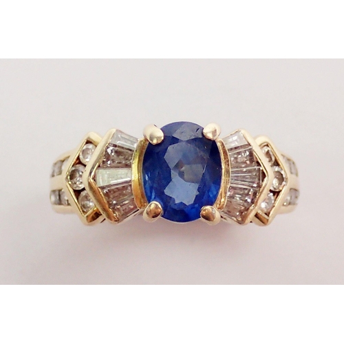 318 - A 9ct gold ring set oval cut blue sapphire on stepped shoulders set baguette and brilliant cut white... 