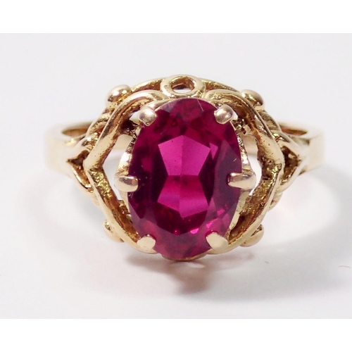 319 - A French 18 carat gold ring set oval cut synthetic ruby, size H, 3.5g