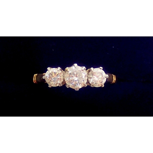 320 - An 18ct gold and platinum set three stone diamond ring, size L, 3g, centre stone 4mm, side stones 3m... 