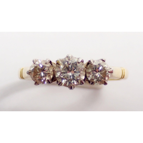 320 - An 18ct gold and platinum set three stone diamond ring, size L, 3g, centre stone 4mm, side stones 3m... 