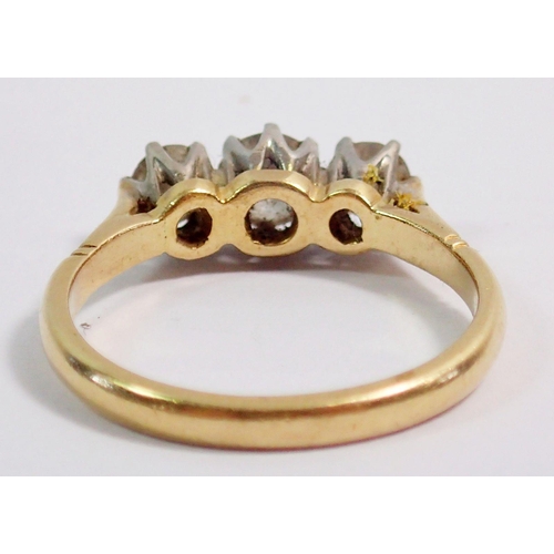 320 - An 18ct gold and platinum set three stone diamond ring, size L, 3g, centre stone 4mm, side stones 3m... 