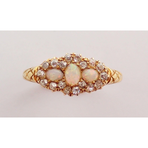 323 - An 18 carat gold ring set three opals within diamond surround, size L-M, 2.5g