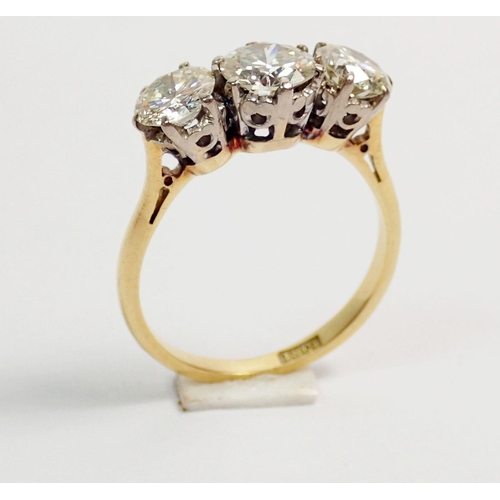 331 - An 18 carat yellow gold three stone diamond ring, size L, 3.5g, centre stone 6mm, side stones 5mm ap... 