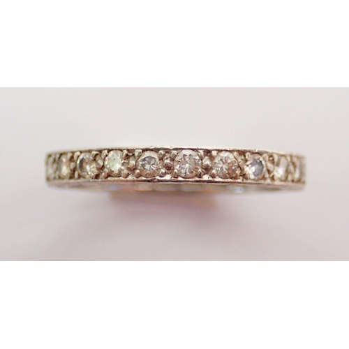 334 - A diamond set full eternity ring set in white metal, size L, 2.8g