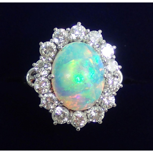 338 - An 18 carat white gold opal and diamond large cluster ring, size N, 7.1g, 2cm x 1.5cm total size