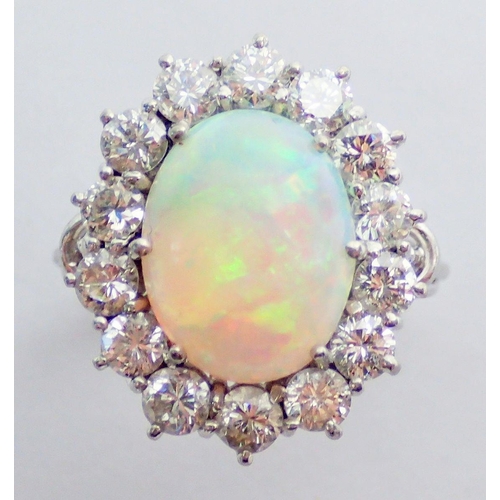 338 - An 18 carat white gold opal and diamond large cluster ring, size N, 7.1g, 2cm x 1.5cm total size