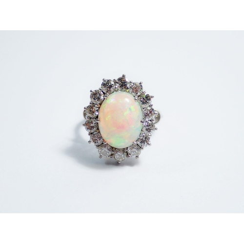 338 - An 18 carat white gold opal and diamond large cluster ring, size N, 7.1g, 2cm x 1.5cm total size