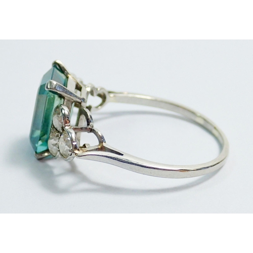 339 - An Art Deco style 18 carat white gold ring set  blue tourmaline flanked by six diamonds, size Q