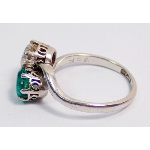 342 - An antique platinum ring crossover set emerald and diamond, size J, 3.6g, the diamond approx. .6cts