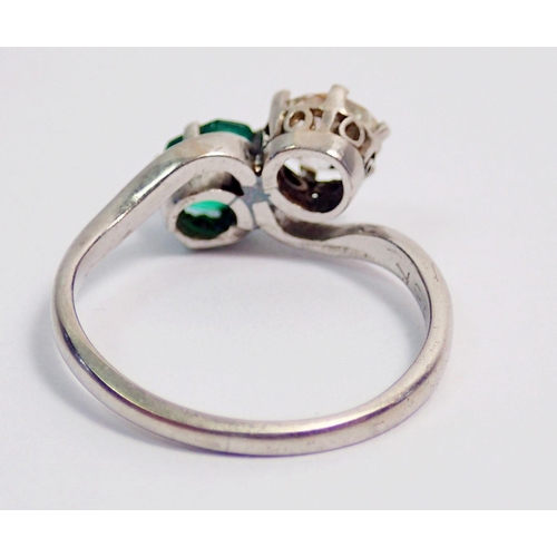 342 - An antique platinum ring crossover set emerald and diamond, size J, 3.6g, the diamond approx. .6cts