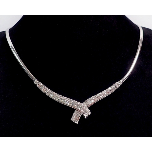 345 - A fine 18 carat white gold collar necklace with crossover front set graduated panels of baguette and... 