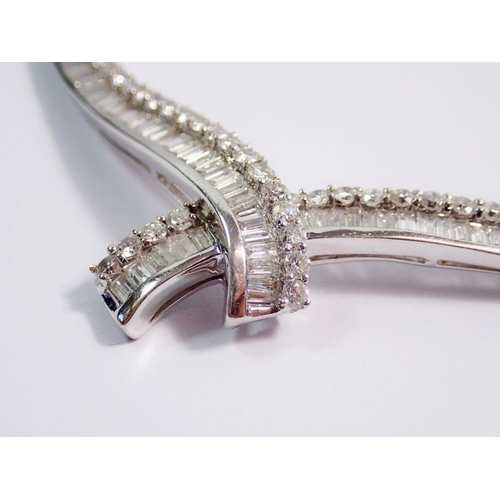 345 - A fine 18 carat white gold collar necklace with crossover front set graduated panels of baguette and... 