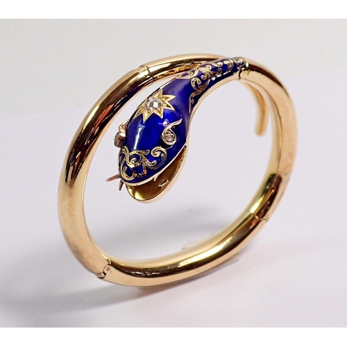 348 - An antique gold snake form bangle with blue enamel and gilt painted head inset diamonds, the open mo... 