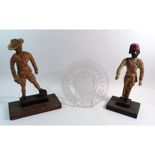 35 - Two unusual Boer War figures (fire damaged) plus a pressed glass Lord Baden Powell plate