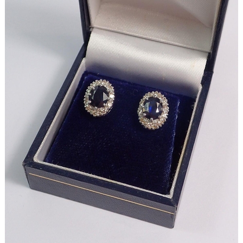 356 - A pair of white gold sapphire and diamond oval cluster earrings, 12mmx9mm, 6.2g