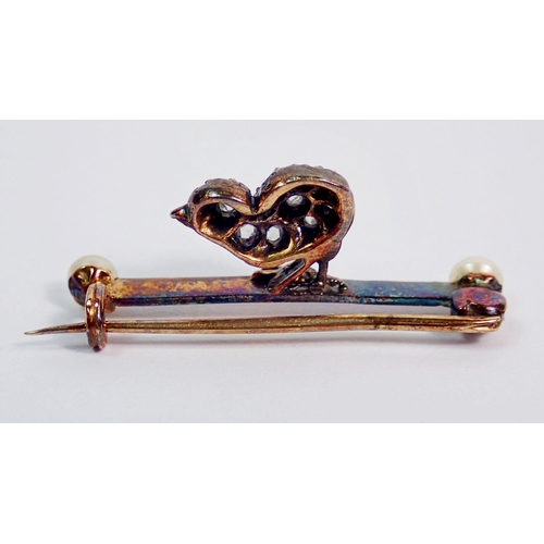 359 - An antique gold bar brooch with chick set old cut diamonds and ruby eye, the bar unmarked with pearl... 