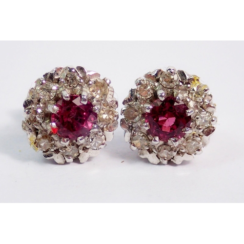 364 - A pair of 9 carat white gold ruby and diamond cluster earrings, 1cm diameter, 2.6g