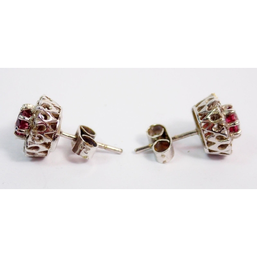 364 - A pair of 9 carat white gold ruby and diamond cluster earrings, 1cm diameter, 2.6g