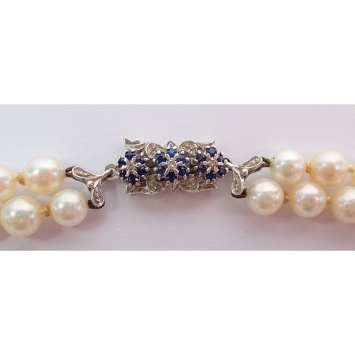 372 - A double row pearl necklace with 18 carat white gold clasp set sapphires, 43cm