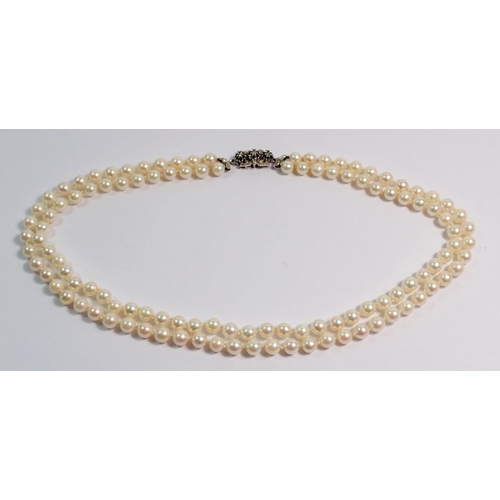 372 - A double row pearl necklace with 18 carat white gold clasp set sapphires, 43cm