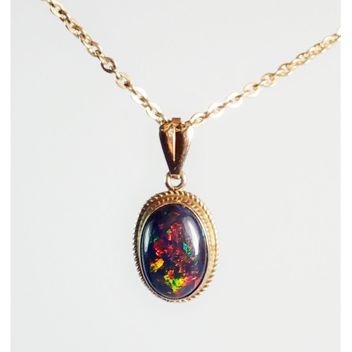 379 - A gold mounted cabochon cut black opal pendant on 9ct gold chain 41cm long 3.2g (pendant not marked)... 