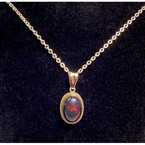 379 - A gold mounted cabochon cut black opal pendant on 9ct gold chain 41cm long 3.2g (pendant not marked)... 