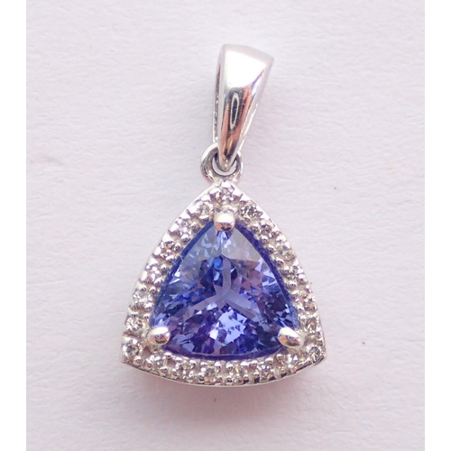 381 - A 14 carat white gold trillion cut tanzanite and diamond set pendant, 1.2g, 1cm across