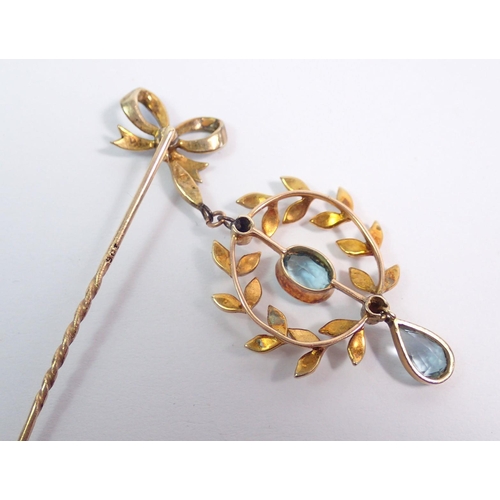 390 - A 9 carat gold Edwardian pendant set aquamarines and seed pearls on enamel bow stick pin, 4.2g