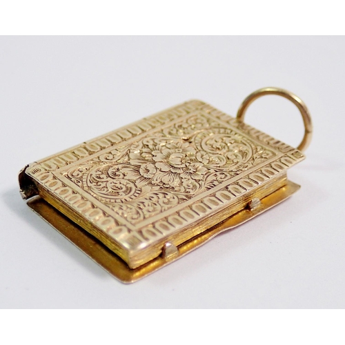 391 - A Victorian gold book form locket with engine turned decoration, 3.3g, 2.3 x 1.1cm, unmarked