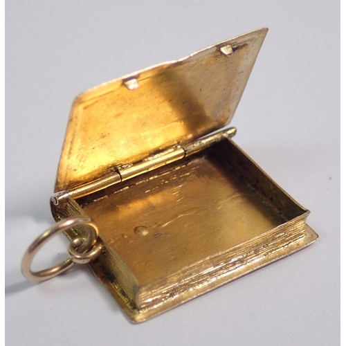 391 - A Victorian gold book form locket with engine turned decoration, 3.3g, 2.3 x 1.1cm, unmarked