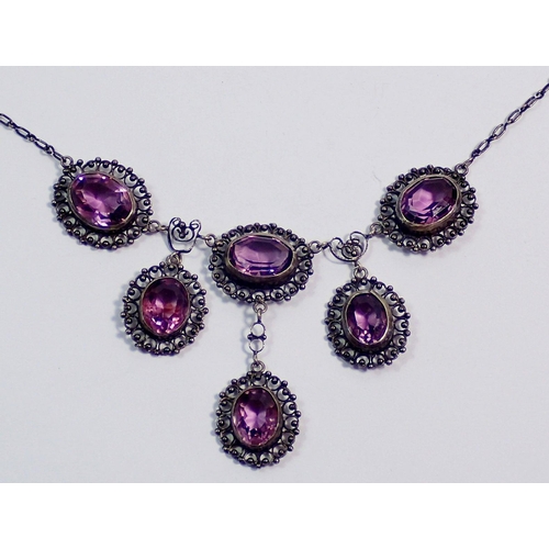 392 - An early 20th century white metal necklace set six oval cut amethysts, clasp a/f