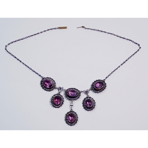 392 - An early 20th century white metal necklace set six oval cut amethysts, clasp a/f